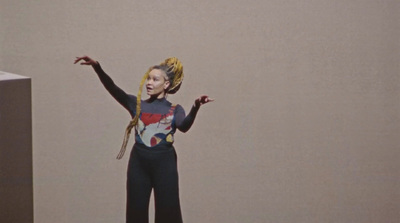 a woman standing on a skateboard in a room