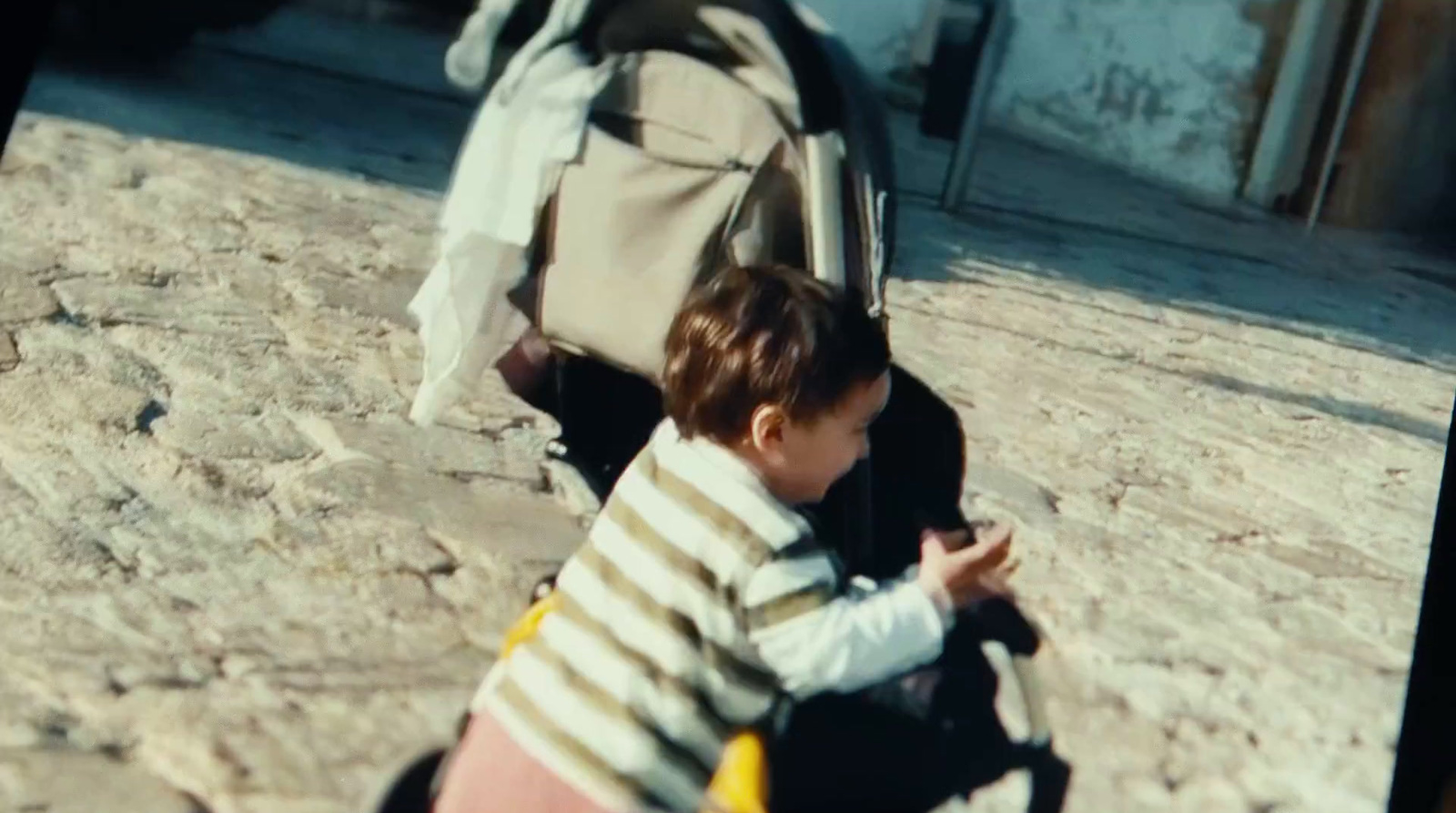 a little boy that is sitting down with a backpack