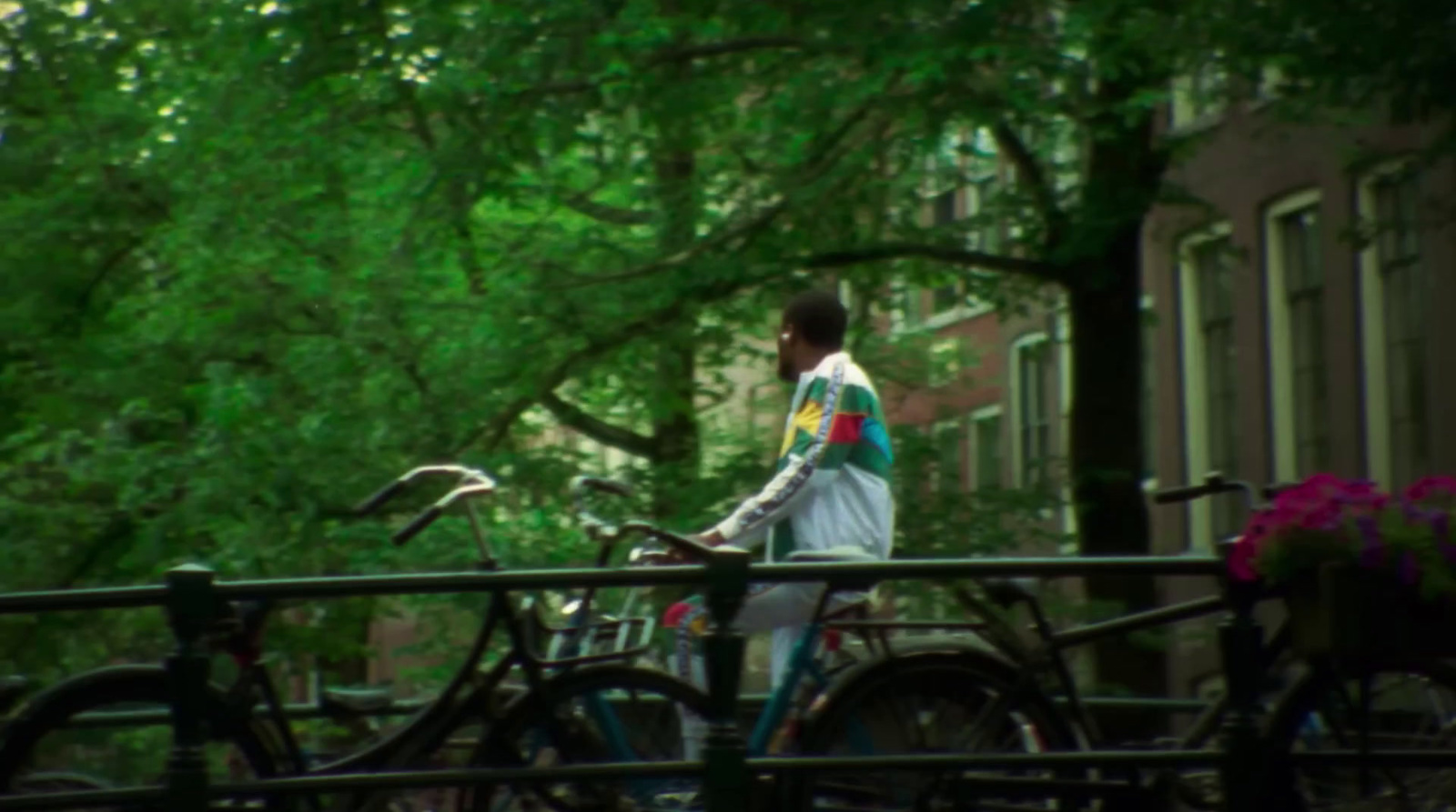 a man standing next to a bunch of bikes