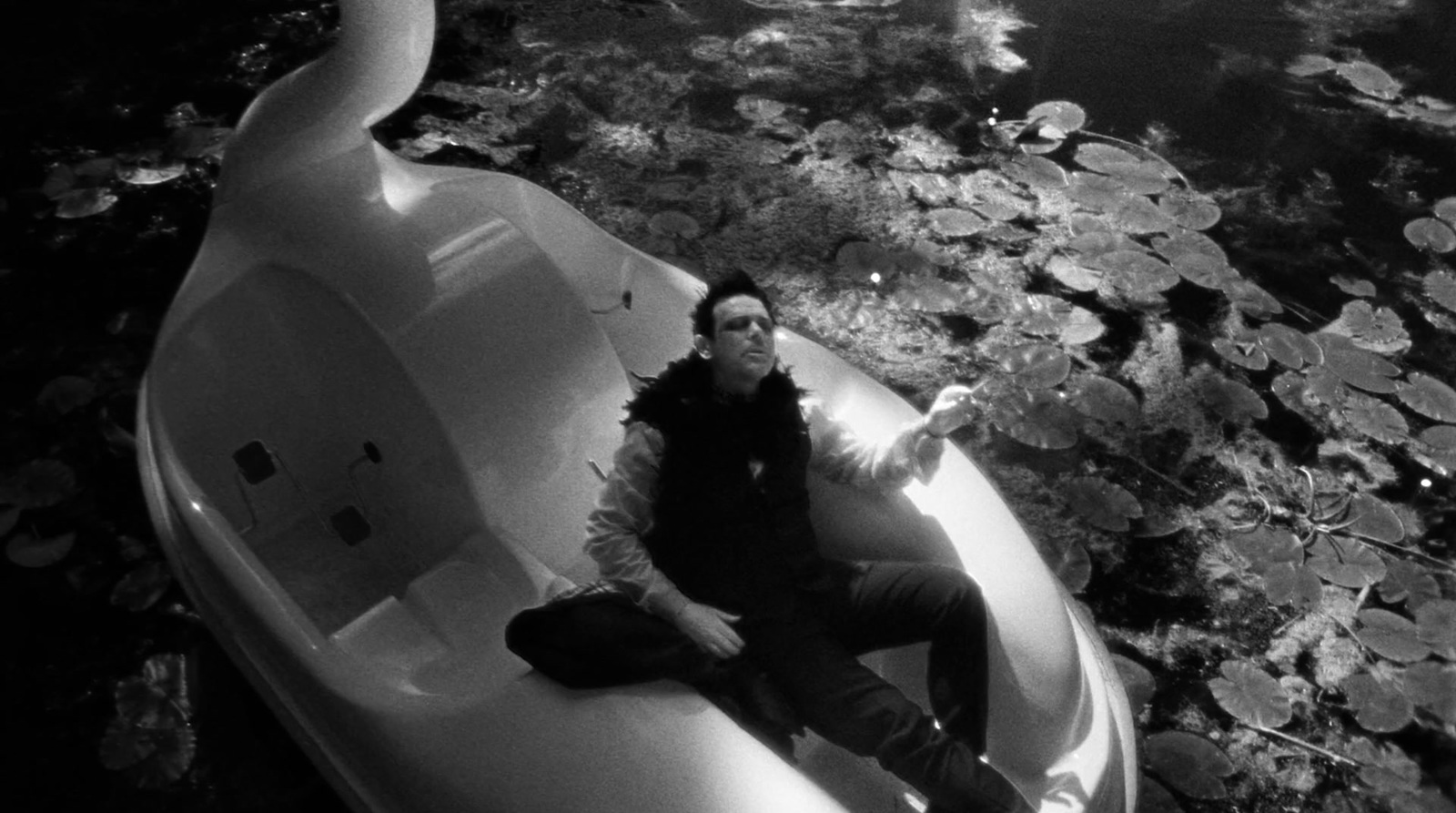 a man sitting in a boat on a body of water