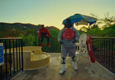 a person with an umbrella standing on a deck