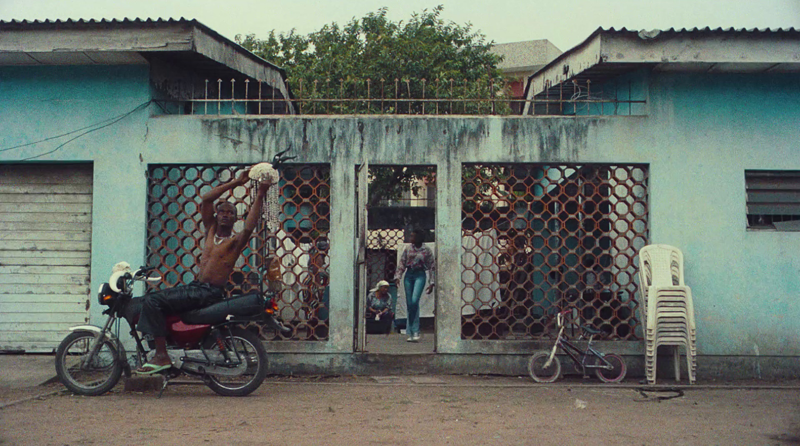 a motorcycle parked in front of a blue building