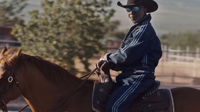 a man riding on the back of a brown horse