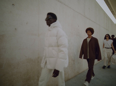 a group of people walking down a sidewalk