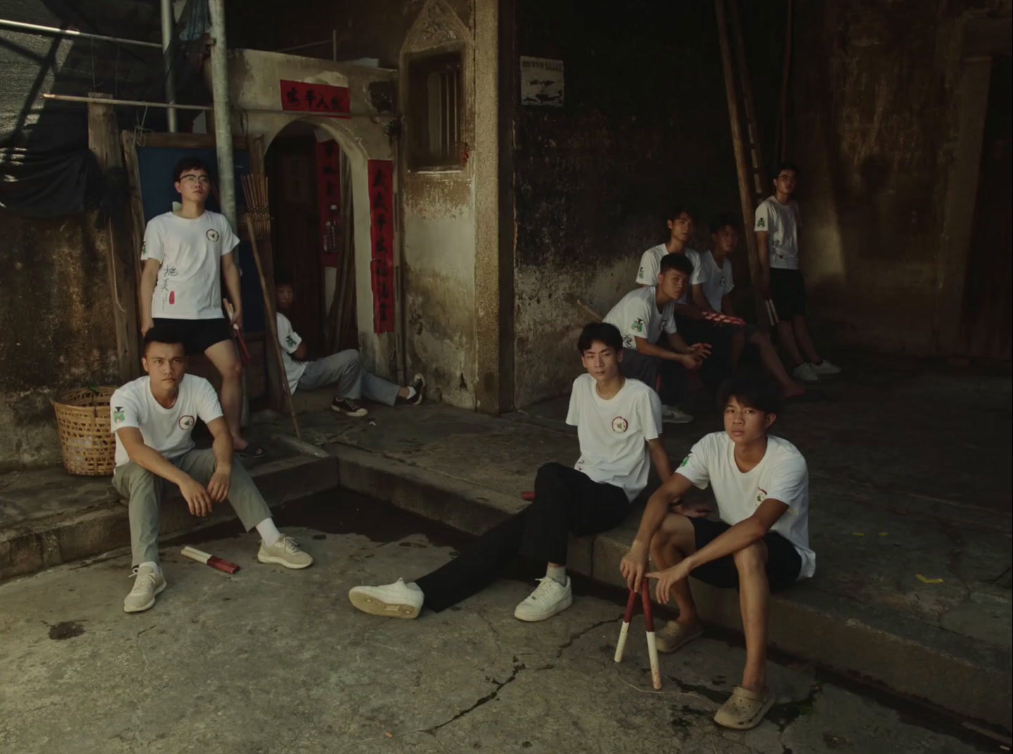 a group of young men sitting on the steps of a building