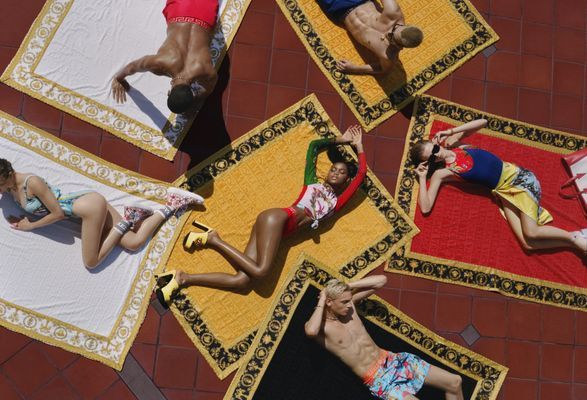 a group of people laying on top of a rug