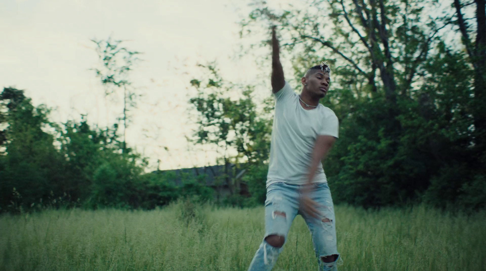 a man standing in a field throwing a frisbee