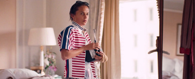 a woman standing in a living room holding a camera