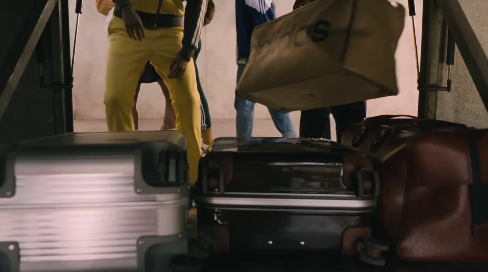 a group of people standing around a pile of luggage