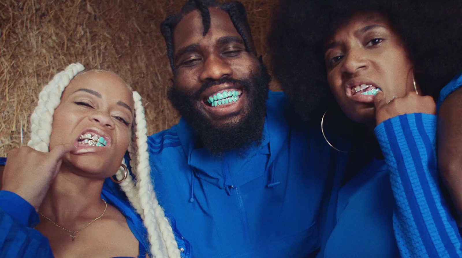 a man and two women brushing their teeth