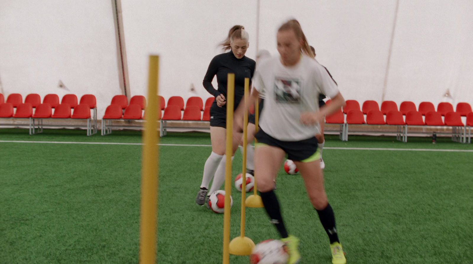 a group of girls playing a game of soccer