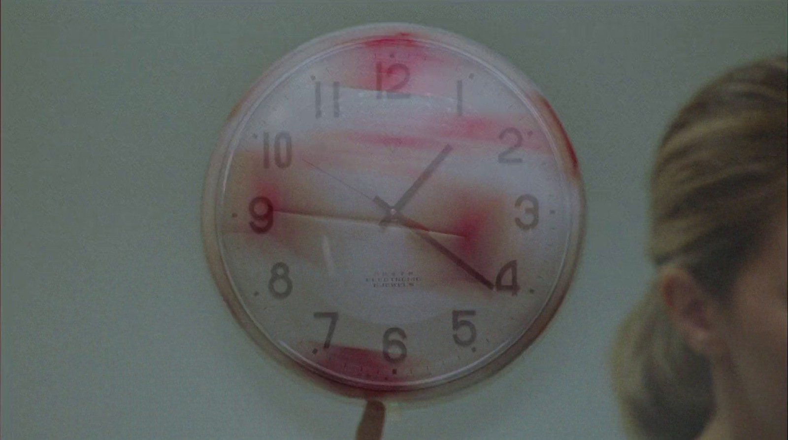 a clock that has blood on the face of it