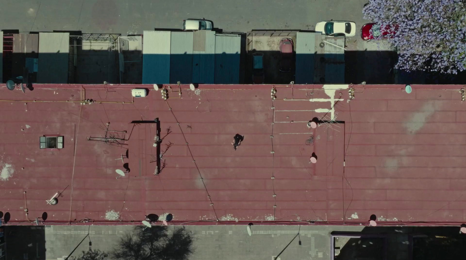 an aerial view of a building with a red roof