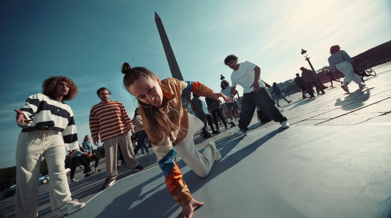 a young girl riding a skateboard down a street