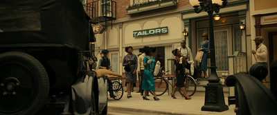 a group of people standing outside of a tall building