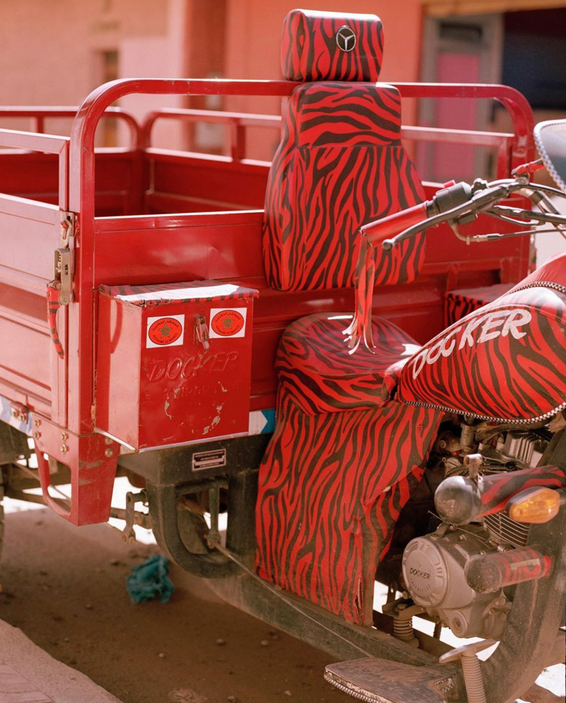 a red motorcycle with a zebra print seat cover