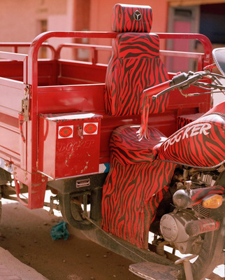 a red motorcycle with a zebra print seat cover