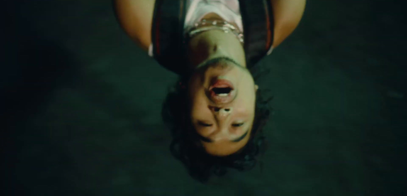 a person upside down on a black surface