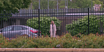 a car parked in front of a black fence