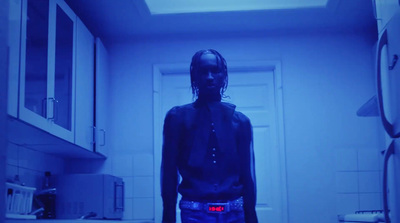 a man standing in a kitchen with blue light