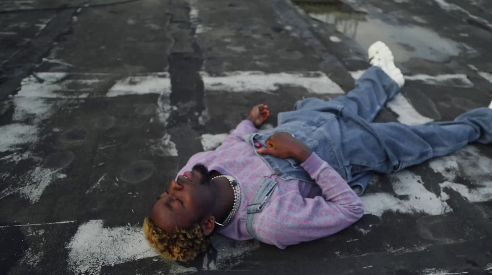 a young girl laying on the ground on her stomach