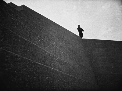 a man standing on top of a stone wall