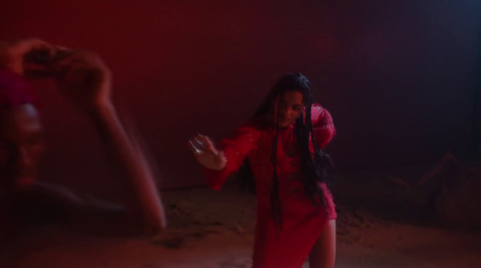 a woman in a red jumpsuit standing in front of a mirror