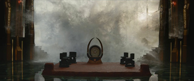 a clock sitting on top of a table in front of a waterfall