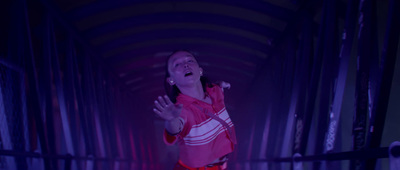 a woman standing in a tunnel with her hands out