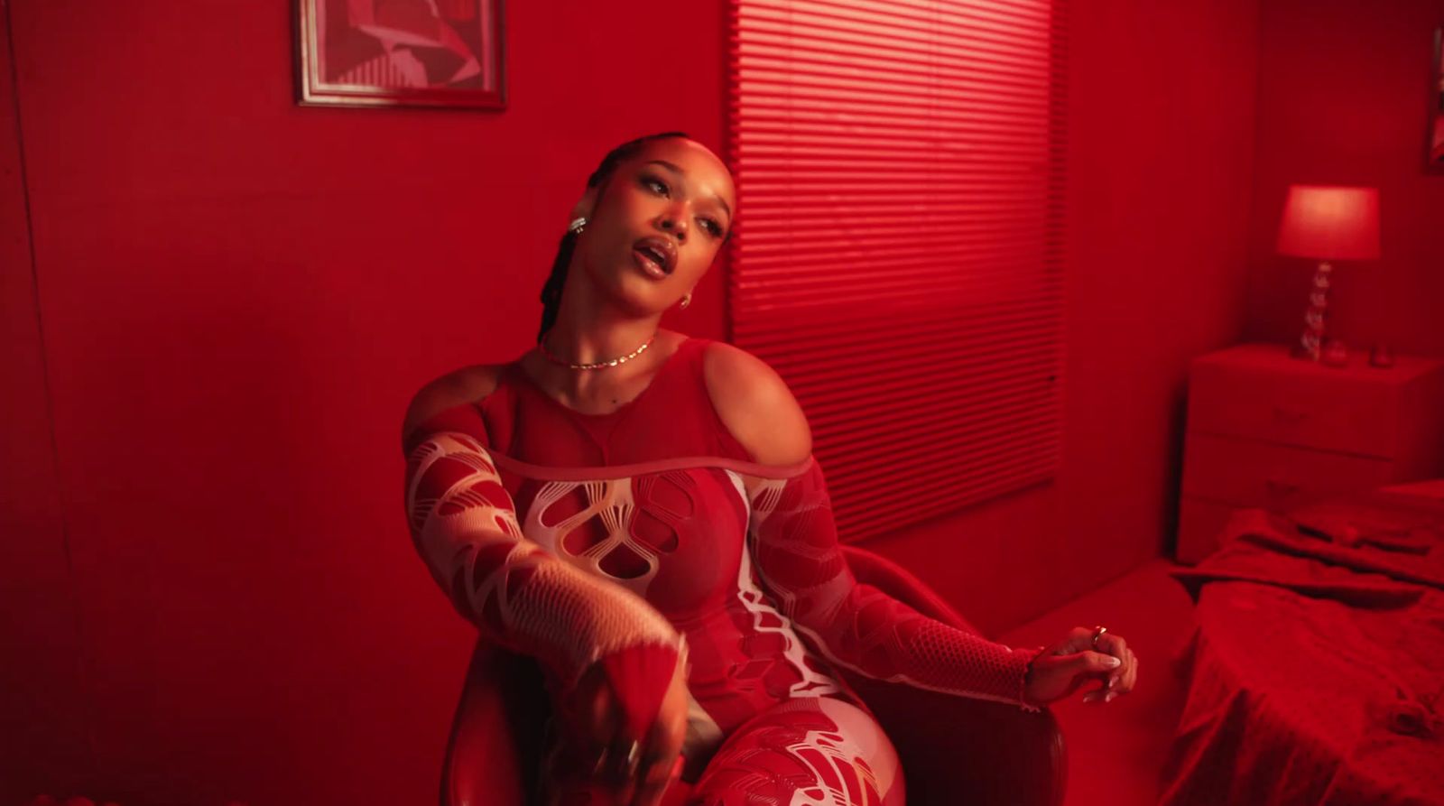 a woman sitting in a chair in a red room