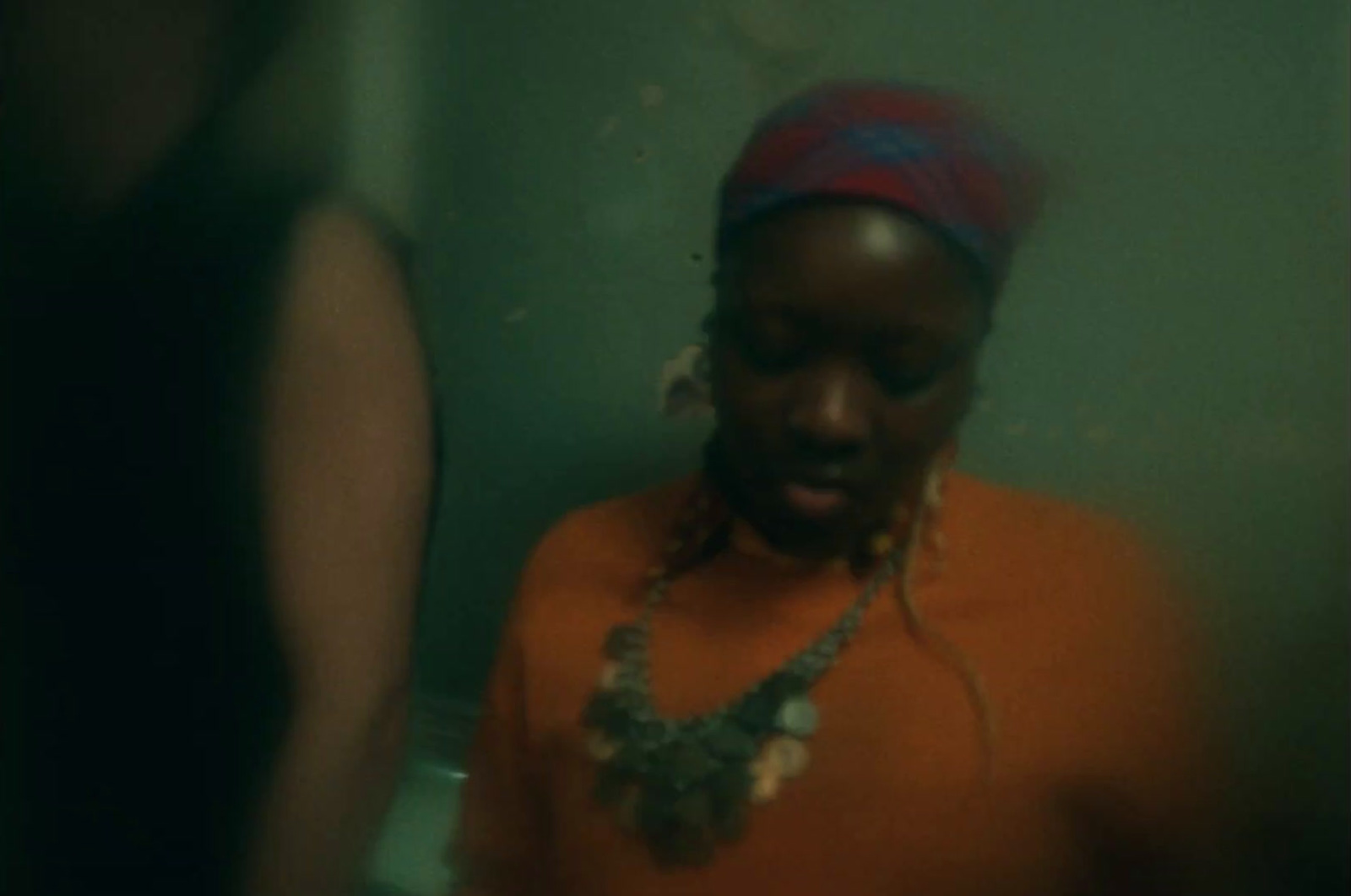 a woman standing in front of a mirror in a bathroom