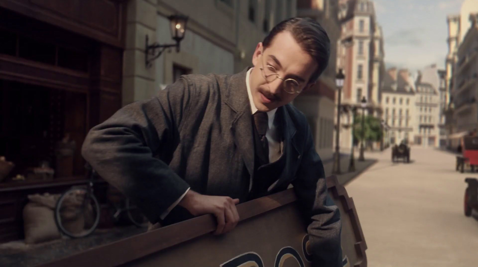 a man in a suit and tie holding a box