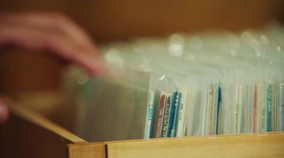 a person holding a plastic bag filled with books