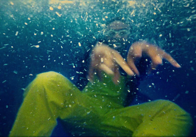 a person sitting under water with a cell phone