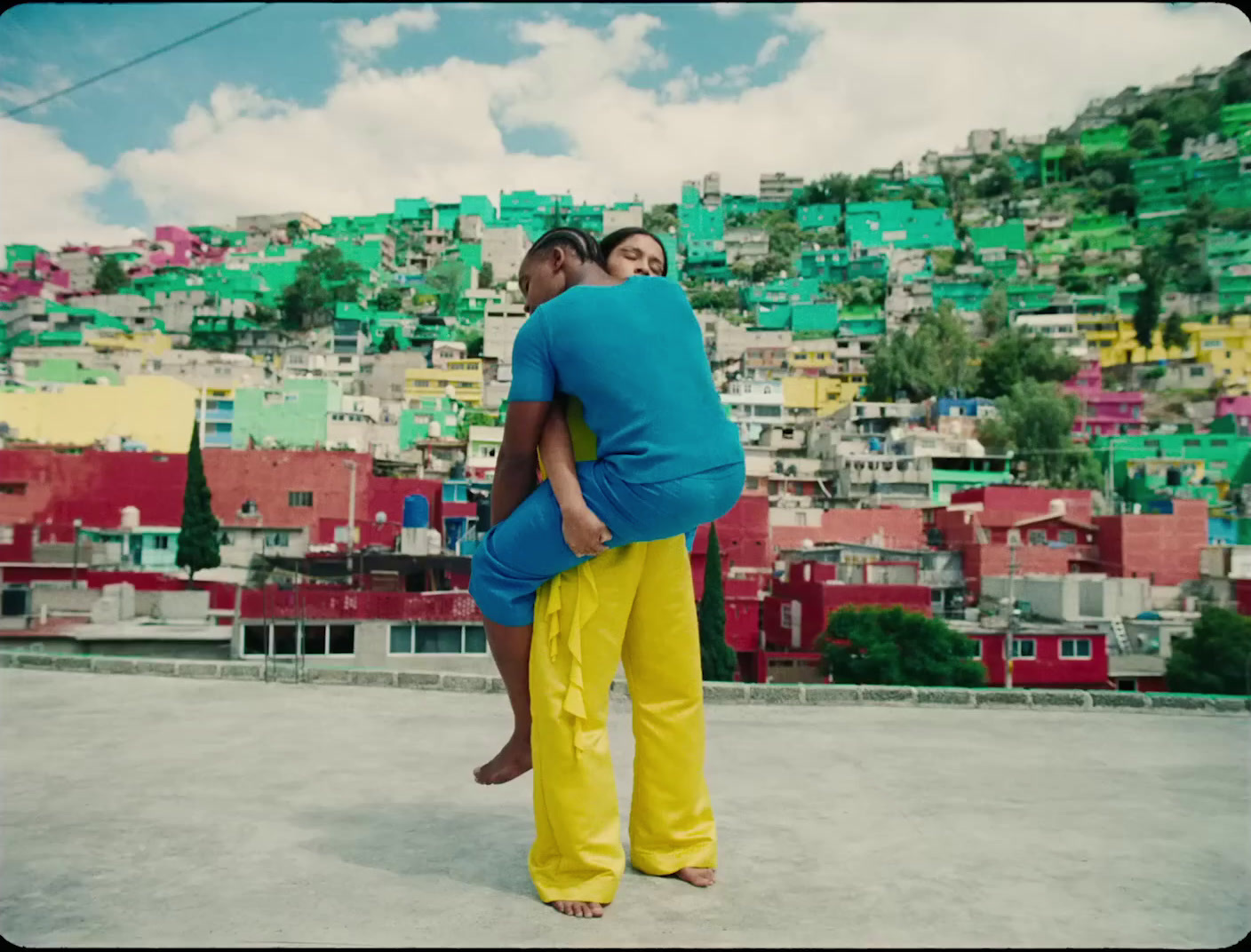 a man and a woman standing in front of a city