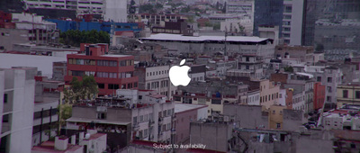 an aerial view of a city with buildings and an apple logo