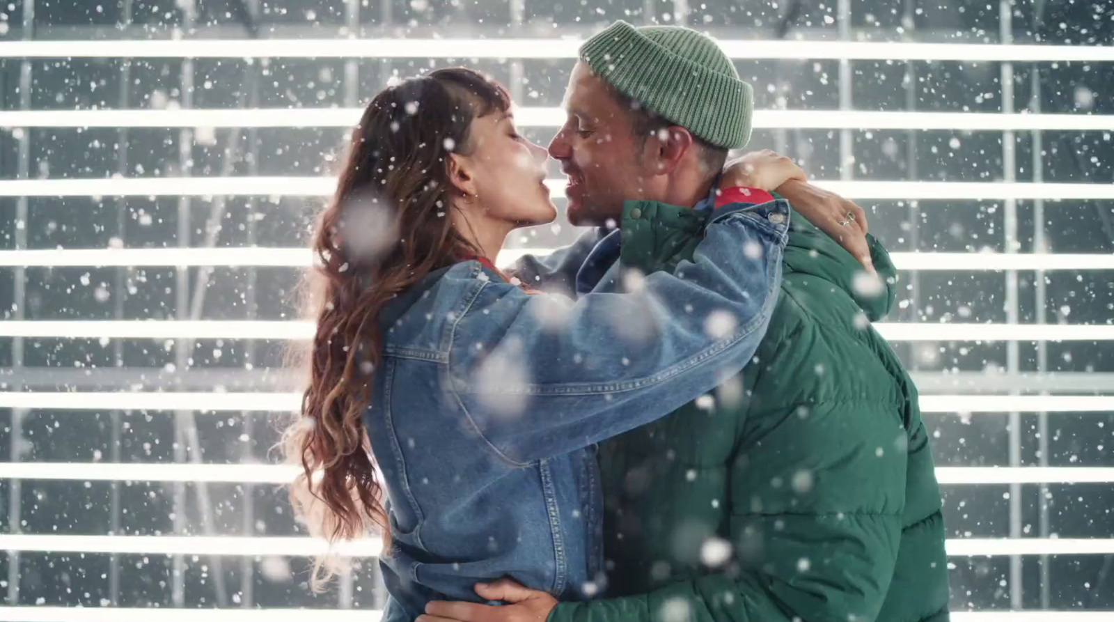 a man and a woman embracing in the snow