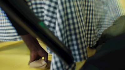 a person standing next to a suitcase on a yellow floor