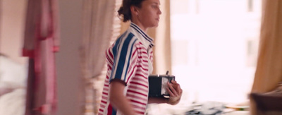 a man in a striped shirt holding a camera