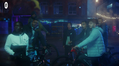 a group of people standing around with bikes