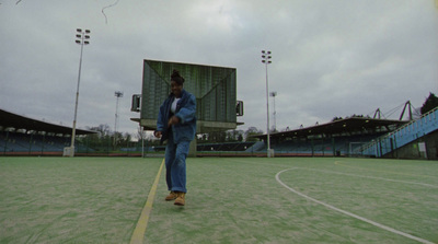 a man standing on a tennis court holding a tennis racquet