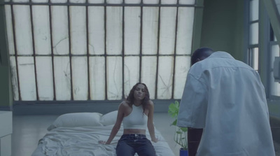 a woman sitting on a bed in a hospital room