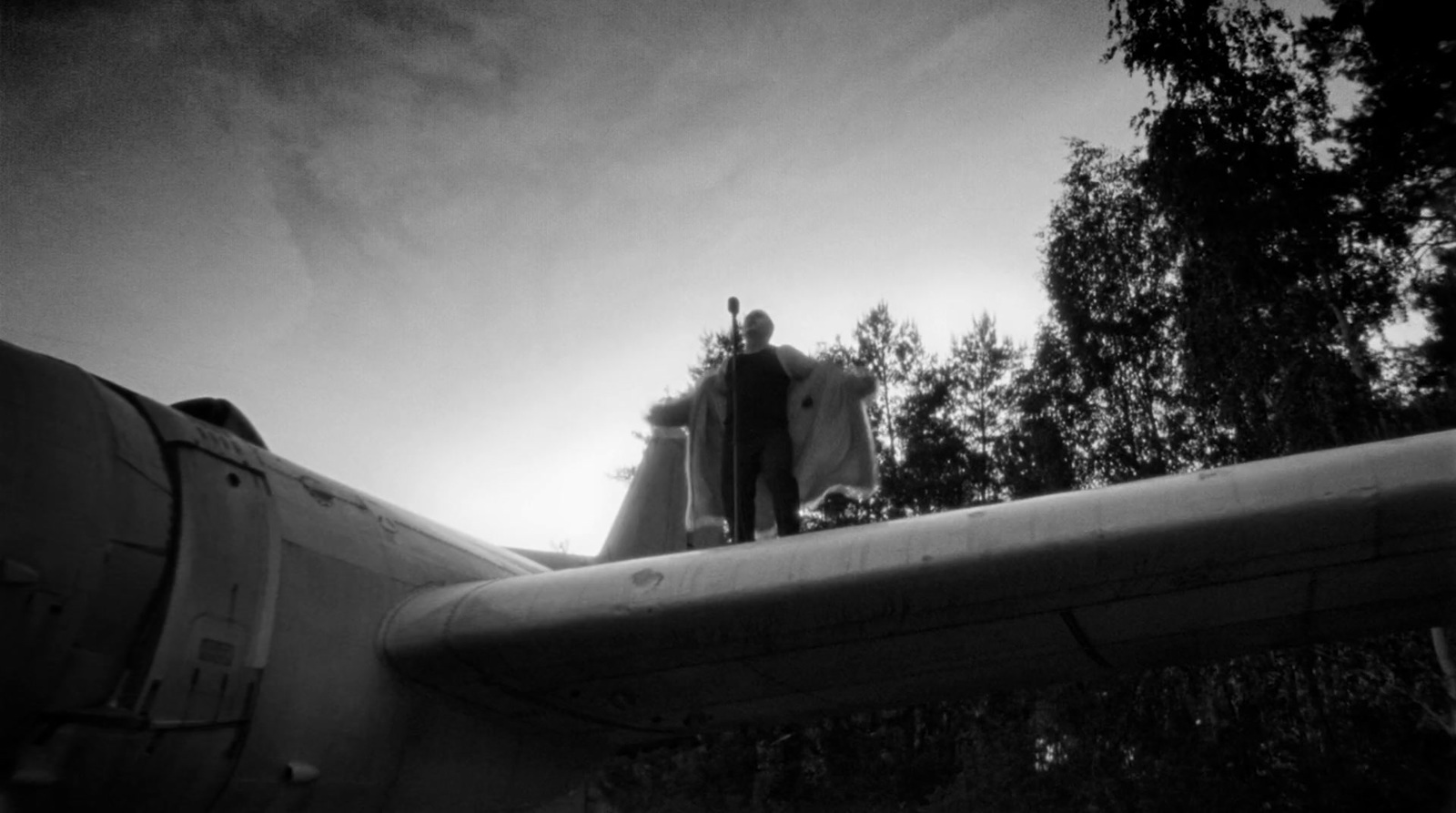 a plane is sitting on the ground with trees in the background