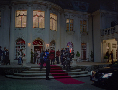 a group of people standing outside of a large building