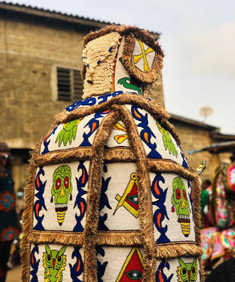 a colorfully decorated bottle sitting in front of a building