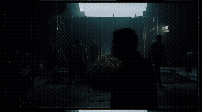 a group of people standing in a dark room