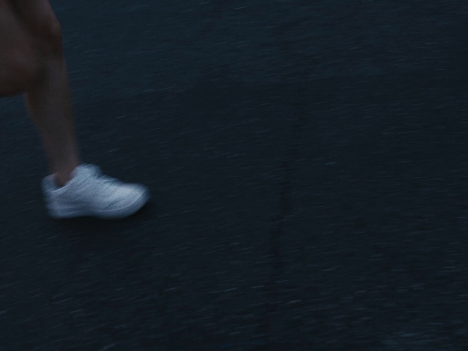 a close up of a person running on a street