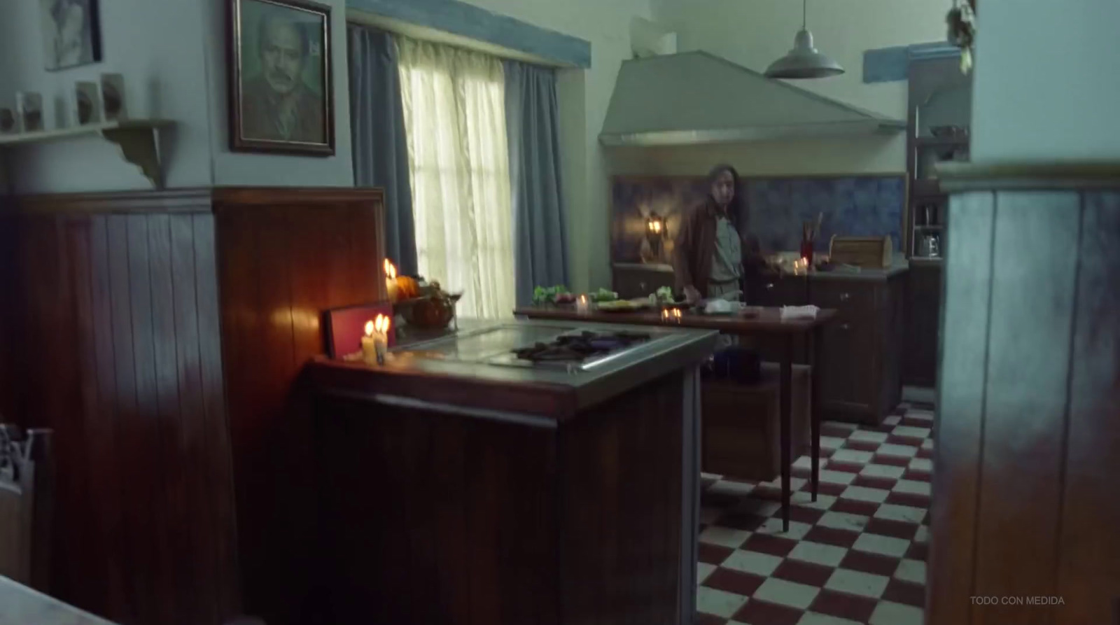 a woman standing in a kitchen next to a stove top oven