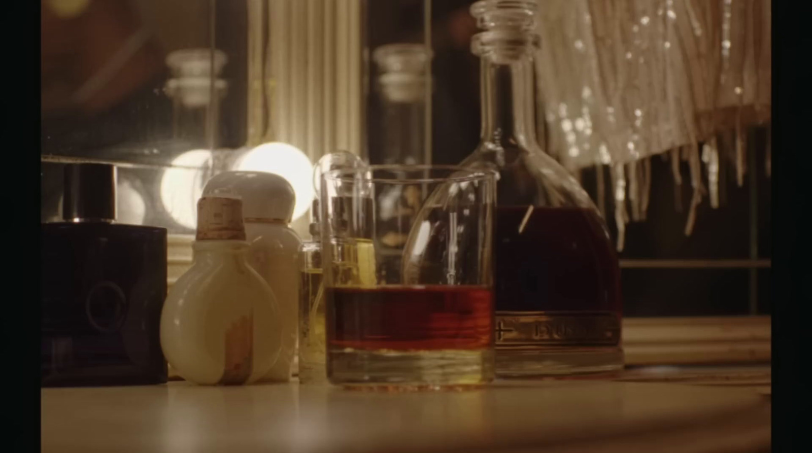 a table topped with bottles of liquor and a mirror