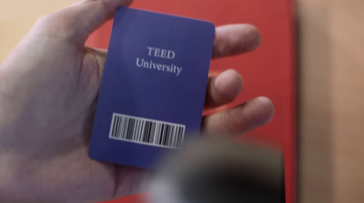 a person holding a blue book with a barcode on it